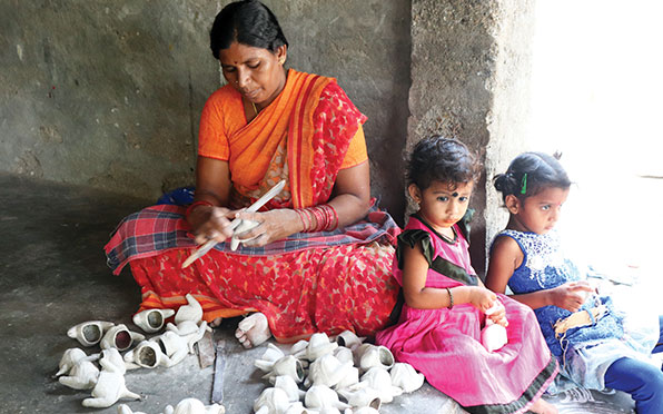 G Kannamma assembles toys at her home; Kondapalli toymaking is a family activity in which the young and the old participate