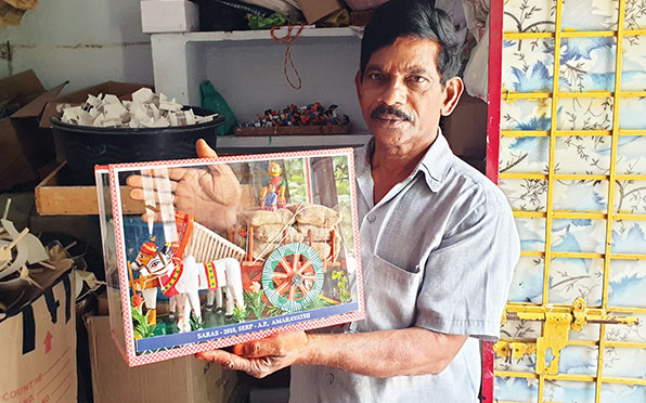 P Satyanarayana with a village scene; Kondapalli toys often depict Hindu mythological figures or rural life