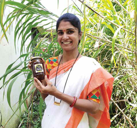 Rohini Patil, an Internet saathi from Adulpeth village in Maharashtra's Satara district, displays her branded line of honey