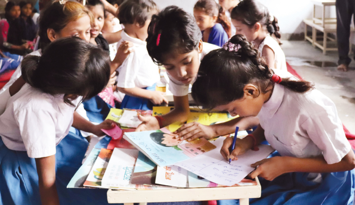 Children updating their library cards at a school in Shravasti in Uttar Pradesh
