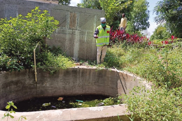 A field worker in the process of deploying the Moskeet device at a site in Hyderabad where mosquitoes breed