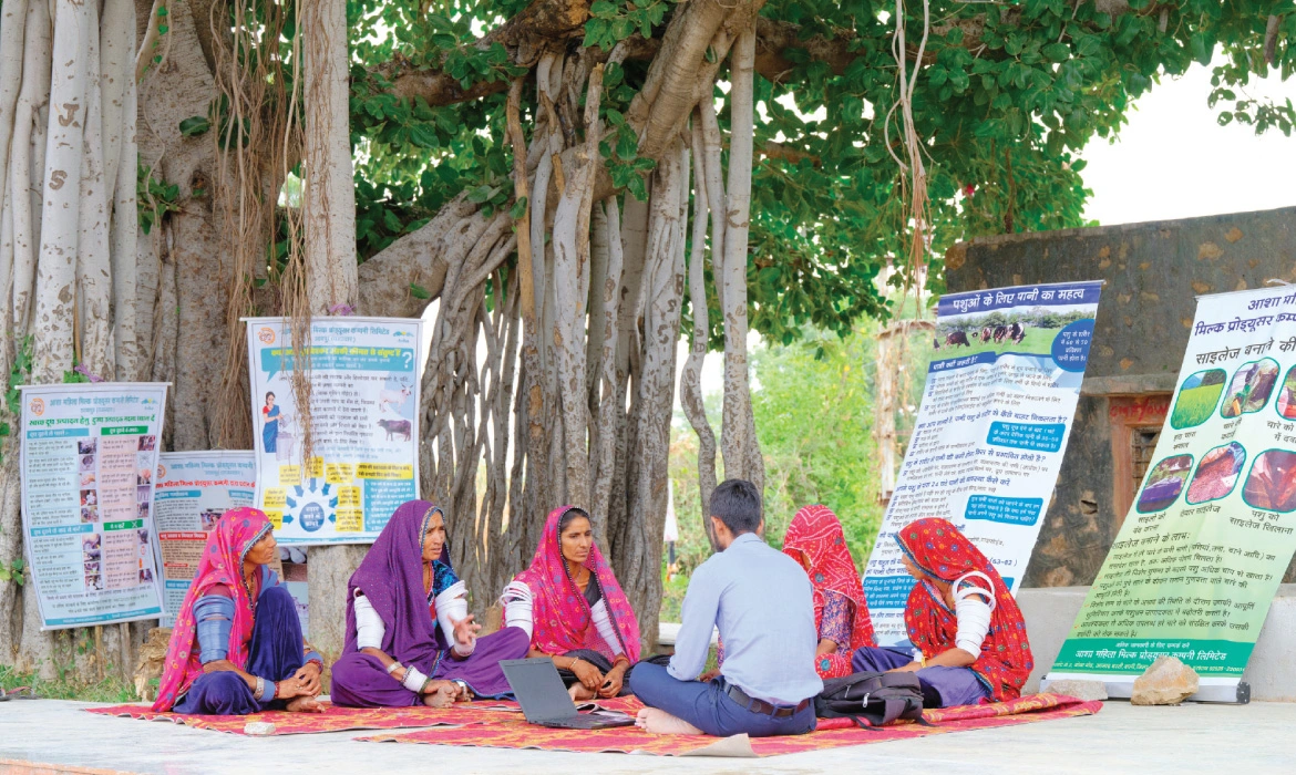 An MPC employee conducts a contact group meeting in a Rajasthan village