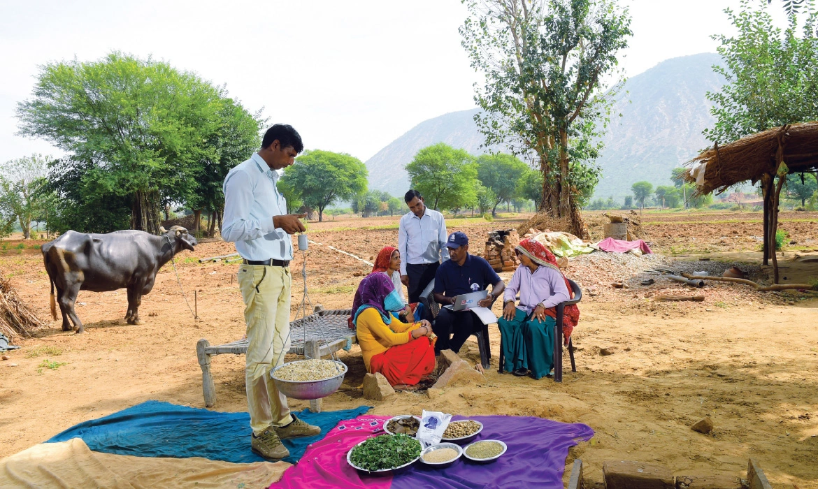 Facilitators from the Sakhi MPC in Alwar talk to farmers about better cattle care