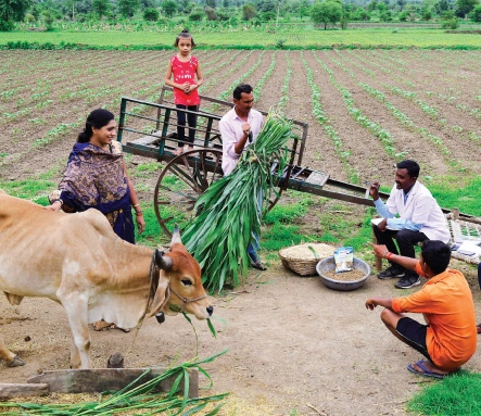A staffer (right) from the Indujaa MPC in Maharashtra with a dairy farming family