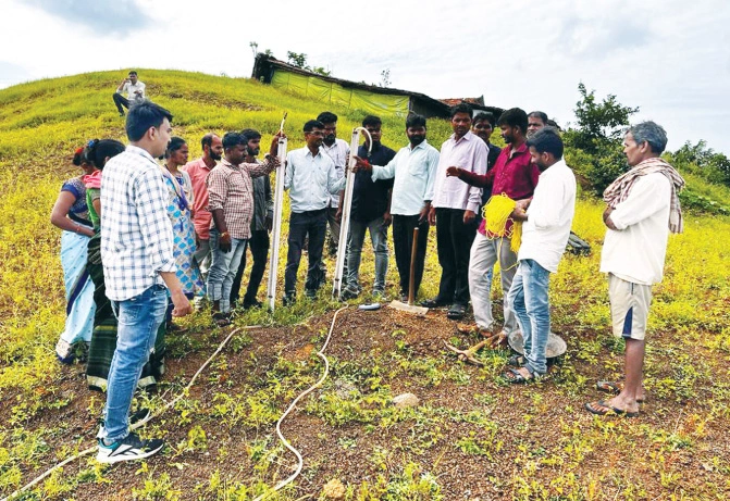 Technical experts and community resource persons educating farmers from Jamana village in Nandurbar district of Maharashtra about water conservation