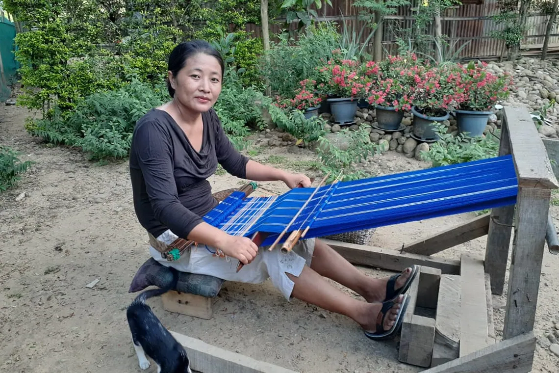 Vekuvolu Dozo weaves a table runner at her home in Naga United in Chümoukedima district