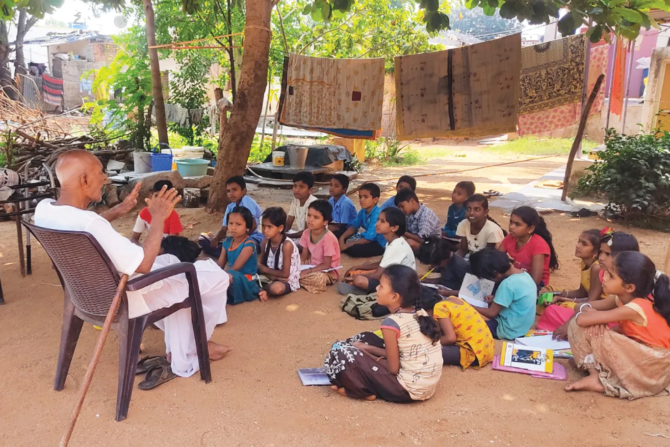 Senior citizen Muddegouda Policepatil sharing stories with children at the government school in Hyati in Koppal district