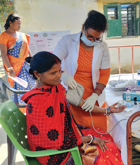 A woman gets checked at a health camp for women and adolescent girls in Kokpara Narsinghgarh village in Jharkhand’s East Singhbum district