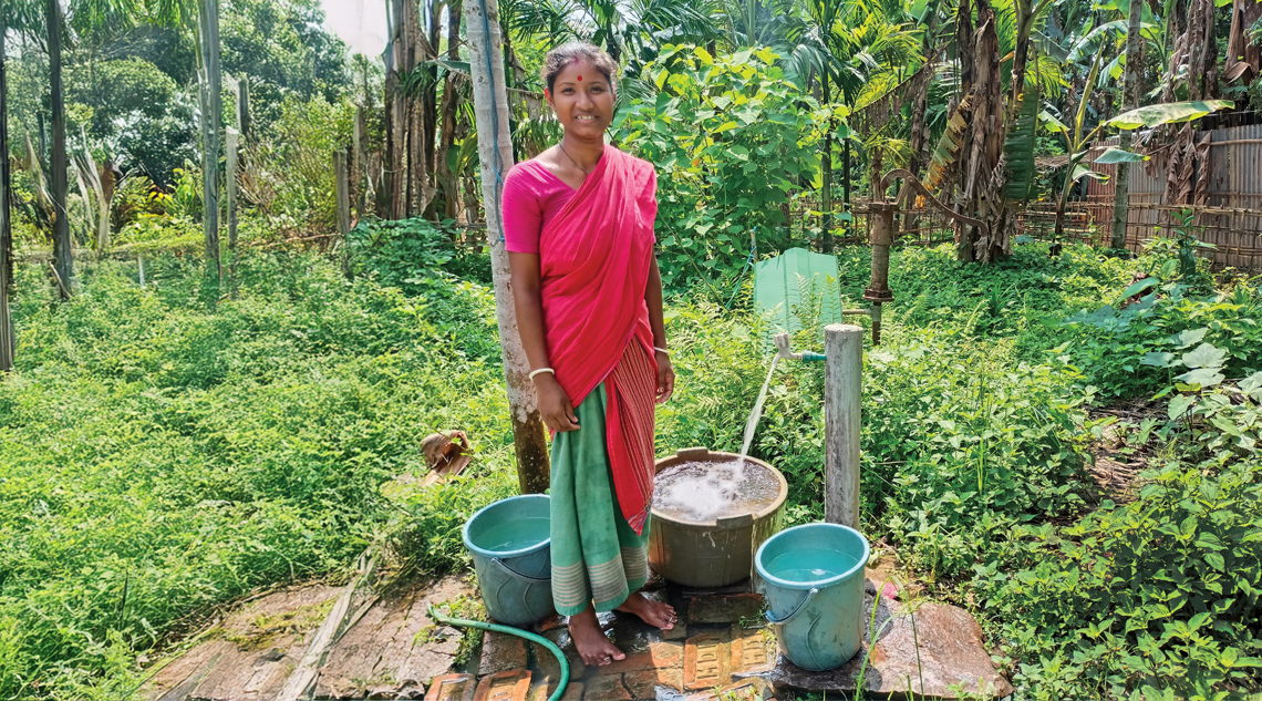 Kusum Bala Das collects water from a tap installed at her home in Barkhal NC village in Assam’s Kamrup district