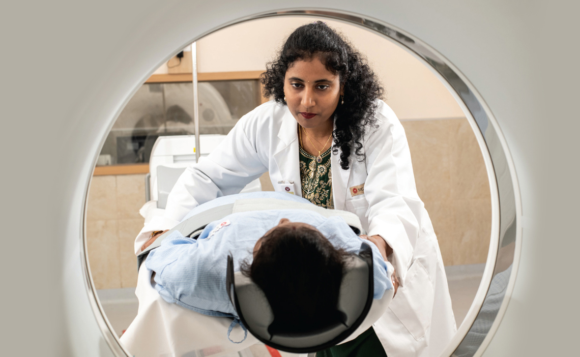 A doctor at SVICCAR in Tirupati, Andhra Pradesh, gets a patient ready for a scan 