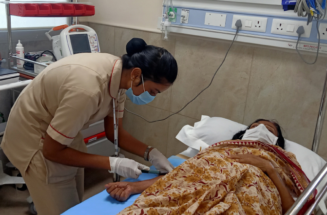 A nurse collecting blood from a patient at SVICCAR in Tirupati, Andhra Pradesh