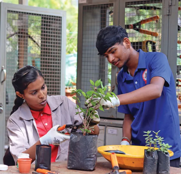 Students get close to plants during a vocational education class at the Dr Vasantdada Patil Madhyamik Vidyaniketan in Pune