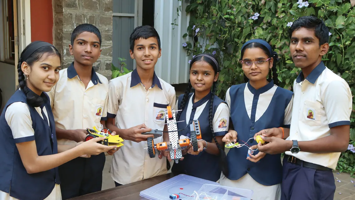 Students at the Hutatma Balveer Shirishkumar High School in Pune with products fashioned during their class on robotics