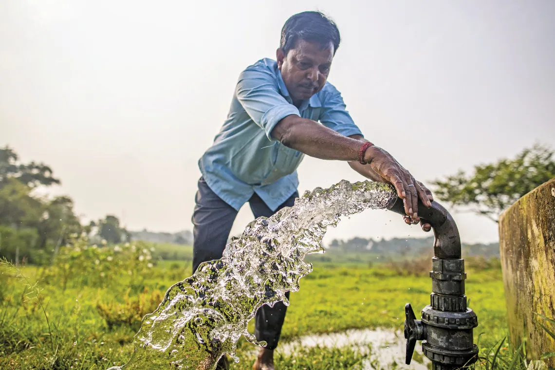 Water entrepreneur Kamdev Pandit, a resident of Birajpur village in Jharkhand’s Deoghar district, checking the flow from his solar-powered water pump