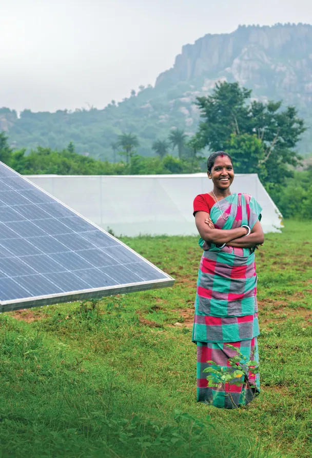 Kiyaful Soren, from Tarbandha village in Jharkhand’s Dumka district, stands near the solar panels that provide the energy required to transport water from a nearby source to her fields